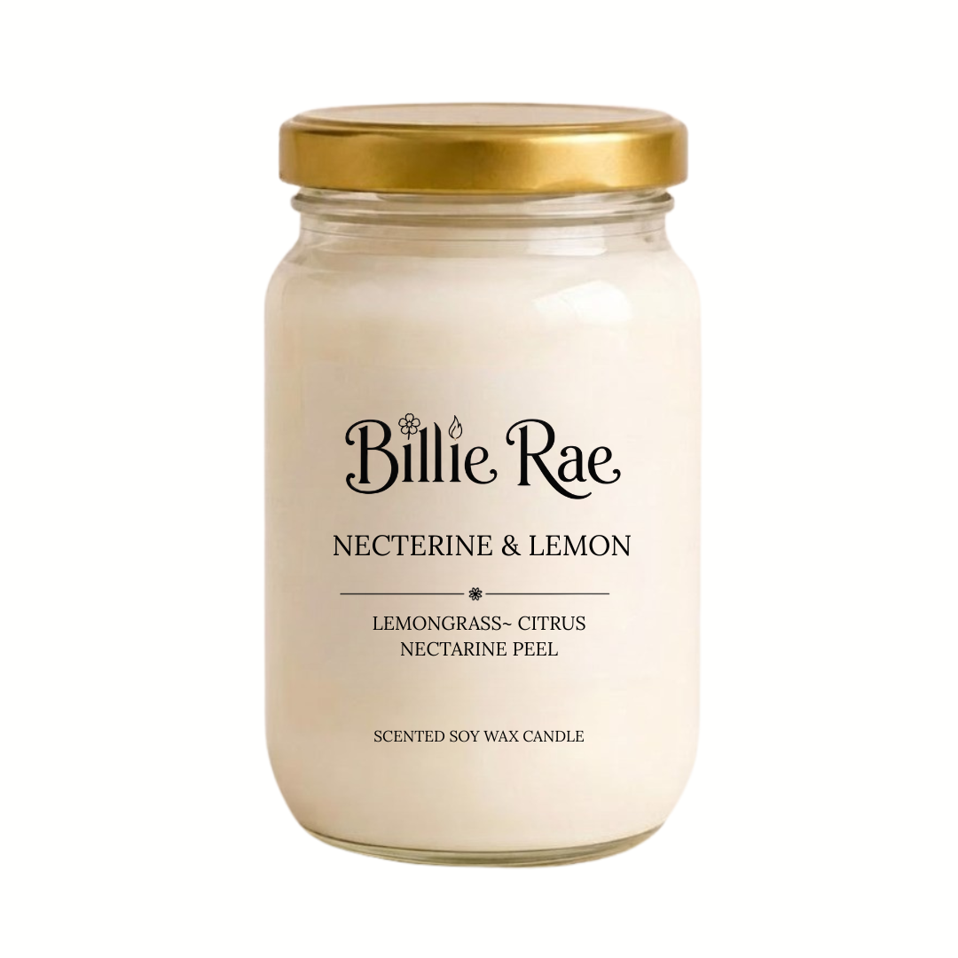 A Billie Rae Nectarine & Lemon scented soy wax candle in a clear glass jar with a gold metal lid, set against a plain white background.