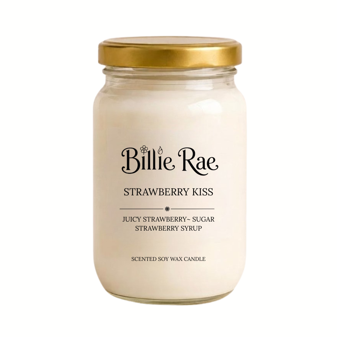 A Billie Rae 'Strawberry Kiss' scented soy wax candle in a clear glass jar with a gold metal lid, set against a plain white background.