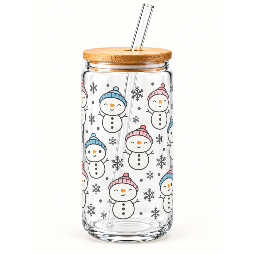 A clear glass tumbler with a bamboo lid and glass straw, decorated with a repeating pattern of smiling snowmen wearing colorful knit hats and small snowflakes.