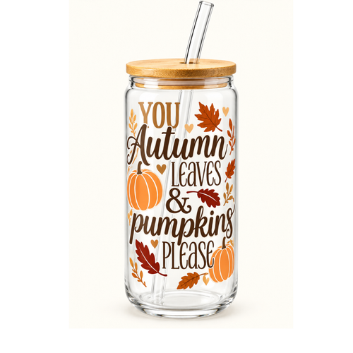 A clear glass tumbler with a bamboo lid and glass straw, featuring an autumn-themed graphic that reads 'YOU Autumn Leaves & pumpkins PLEASE' with pumpkins, leaves, and hearts in orange, brown, and gold tones.