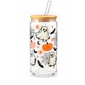 A clear glass tumbler with a bamboo lid and glass straw, decorated with a Halloween pattern featuring cartoon ghosts, pumpkins, bats, and spiderwebs on a white background.