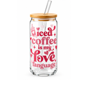 A clear glass tumbler with a bamboo lid and clear straw, featuring the phrase 'iced coffee is my love language' in pink and red lettering with heart accents, on a white background.